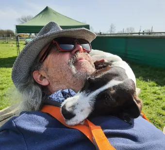 Peter having a cuddle with Frankie at Doggie Day Care