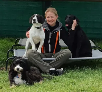 Sara relaxing with dogs at Doggie Day Care in Dorchester